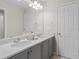 Bright bathroom featuring double sinks, white countertops and gray cabinets at 16421 Askins Loop, Parker, CO 80134