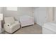 Comfortable Bedroom features a crib, chair, and changing table for a welcoming space at 16421 Askins Loop, Parker, CO 80134