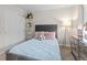 Cozy bedroom with plush gray headboard and blue patterned bedding at 16421 Askins Loop, Parker, CO 80134