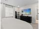 Bright bedroom boasts a dresser, TV, and inviting atmosphere, perfect for relaxation at 16421 Askins Loop, Parker, CO 80134