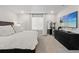 Bright bedroom features a plush bed, dresser, and modern TV for comfortable living at 16421 Askins Loop, Parker, CO 80134