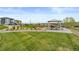 Community area featuring open green space, picnic tables, and playground at 16421 Askins Loop, Parker, CO 80134
