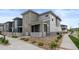 Charming two-story home showcasing its modern design, stone facade, and manicured landscaping at 16421 Askins Loop, Parker, CO 80134