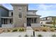 Beautiful gray two-story home featuring stone accents, well-maintained landscaping, and a welcoming front porch at 16421 Askins Loop, Parker, CO 80134