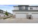 Exterior shot of townhome with a large garage and well-kept landscaping at 16421 Askins Loop, Parker, CO 80134