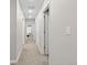 Bright hallway with multiple doors and neutral paint, offering a glimpse into other rooms at 16421 Askins Loop, Parker, CO 80134