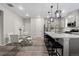 Bright kitchen with modern lighting, stainless steel appliances, and a large center island with bar seating at 16421 Askins Loop, Parker, CO 80134