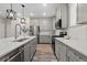 Spacious kitchen with stainless steel appliances, gray cabinets, a tile backsplash and an island sink at 16421 Askins Loop, Parker, CO 80134