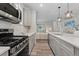 Modern kitchen featuring gray cabinetry, stainless steel appliances, and open layout at 16421 Askins Loop, Parker, CO 80134