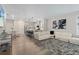 Open-concept living room and kitchen with modern lighting, hardwood floors, and stylish decor at 16421 Askins Loop, Parker, CO 80134