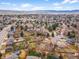 Aerial view showcasing the neighborhood, proximity to parks, and the home's location among mature trees and well-kept yards at 7604 S Lamar Ct, Littleton, CO 80128