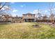 Spacious backyard featuring a well-manicured lawn and a covered patio at 7604 S Lamar Ct, Littleton, CO 80128