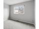 Simple bedroom with carpet, neutral walls, and natural light from a bright window at 7604 S Lamar Ct, Littleton, CO 80128