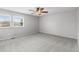 Neutral bedroom featuring carpet, a ceiling fan, and natural light from windows at 7604 S Lamar Ct, Littleton, CO 80128