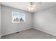 Clean bedroom with carpet, neutral walls, ceiling fan, and a bright window at 7604 S Lamar Ct, Littleton, CO 80128