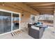 Relaxing covered patio with comfortable seating, a fire pit table, and outdoor lighting at 7604 S Lamar Ct, Littleton, CO 80128
