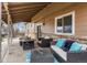 Relaxing covered patio with comfortable seating, a fire pit table, and outdoor lighting at 7604 S Lamar Ct, Littleton, CO 80128