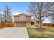 Charming two-story home with a well-maintained lawn and a two car garage at 7604 S Lamar Ct, Littleton, CO 80128