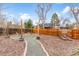 Backyard firepit with Adirondack chairs and custom lighting is great for entertaining at 7604 S Lamar Ct, Littleton, CO 80128