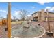 Backyard firepit with Adirondack chairs and custom lighting is great for entertaining at 7604 S Lamar Ct, Littleton, CO 80128
