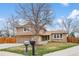 Inviting home featuring a well-kept lawn and a classic exterior design with a brick and siding combination at 7604 S Lamar Ct, Littleton, CO 80128