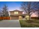 Charming two-story home with a two-car garage, brick accents, and a well-maintained front yard at 7604 S Lamar Ct, Littleton, CO 80128