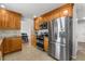 Kitchen with stainless steel refrigerator and eat-in dining area at 7604 S Lamar Ct, Littleton, CO 80128