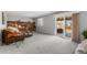 Inviting living room with a brick fireplace and sliding glass doors to the backyard at 7604 S Lamar Ct, Littleton, CO 80128