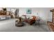 Bright living room with plush seating, accent tables, and staircase views at 7604 S Lamar Ct, Littleton, CO 80128