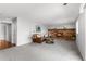 Bright living room with a brick fireplace, gray carpet, and a cozy seating area at 7604 S Lamar Ct, Littleton, CO 80128