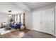 Inviting living room showcasing a blue sofa and decorative front doors at 7604 S Lamar Ct, Littleton, CO 80128