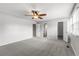 Spacious main bedroom with two closets, ceiling fan, and natural light at 7604 S Lamar Ct, Littleton, CO 80128