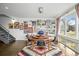 Bright dining room with a round table, rug, gallery wall, and staircase at 4390 Osage St, Denver, CO 80211