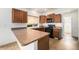 Well-equipped kitchen with plenty of counter space, wood cabinets, and black appliances at 5572 Killarney St, Denver, CO 80249