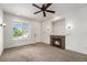 Inviting living room with fireplace, ceiling fan, and natural light, creating a cozy atmosphere at 5572 Killarney St, Denver, CO 80249