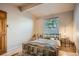 Cozy bedroom featuring hardwood floors, a comfortable bed, and a bright window at 8168 Washington St # 46, Denver, CO 80229