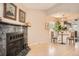 Cozy living room featuring a fireplace, hardwood floors, and an adjacent dining area at 8168 Washington St # 46, Denver, CO 80229