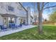 Large backyard with a patio, chairs, string lights, and expansive lawn area at 10984 Alcott Dr, Denver, CO 80234