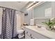 Bright bathroom with a shower-tub combo and modern fixtures at 10984 Alcott Dr, Denver, CO 80234