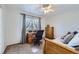 Cozy bedroom with natural light, desk, plush carpet, and comfortable bed at 10984 Alcott Dr, Denver, CO 80234