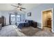 Comfortable carpeted bedroom with vaulted ceilings, ceiling fan, and natural light at 10984 Alcott Dr, Denver, CO 80234
