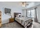 Airy bedroom with natural light, ceiling fan, plush carpet, and modern decor at 10984 Alcott Dr, Denver, CO 80234