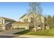 Beautiful two-story home with a three-car garage and a well-maintained lawn at 10984 Alcott Dr, Denver, CO 80234