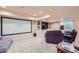 Basement home theater with a large screen, comfortable seating and recessed lighting at 10984 Alcott Dr, Denver, CO 80234