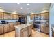 Spacious kitchen featuring an island, granite countertops, and stainless steel appliances at 10984 Alcott Dr, Denver, CO 80234