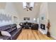 Spacious living room featuring skylights, hardwood floors, and a cozy fireplace at 10984 Alcott Dr, Denver, CO 80234