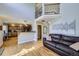 Open-concept living room with hardwood floors and access to kitchen at 10984 Alcott Dr, Denver, CO 80234