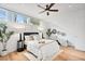 Comfortable bedroom featuring a ceiling fan and bright natural light from the windows at 2640 Central Ct # 204, Denver, CO 80211