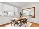 Cozy dining area featuring hardwood floors, a modern table set, and a large mirror at 2640 Central Ct # 204, Denver, CO 80211