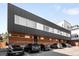 Modern apartment building exterior featuring mixed materials and ample parking at 2640 Central Ct # 204, Denver, CO 80211